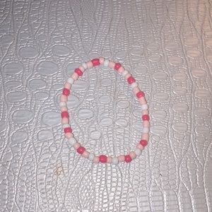 I’m selling bracelets! Colors: bright pink,light pink, and white